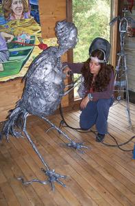 One of the artists selected for the 2007 show, Mary Tartaro, puts the finishing touches on one of her sculptures.