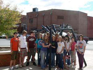 Bristol art students gather around "In the Belly of the Beast," one of the sculptures on the Art in Public Places Walking Tour.