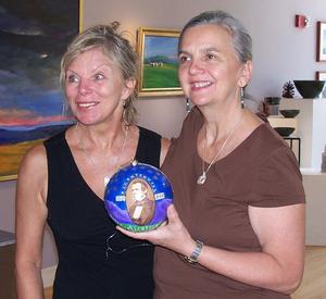 Martha Scull and Patty Lane hold their ornament  commemorating the  bicentennial of Andrew Johnson's birthday.