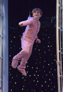 With a safety harness, Logan Fritz learns to "fly" for his role as Michael Darling in Peter Pan at Barter Theatre.