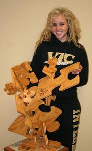 Lindsey Smith and her sculpture, "Puzzled Wood."
