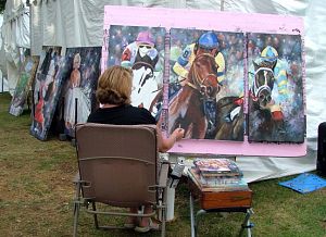 Kimberly Erb, a painter from New Philidelphia, Ohio, puts some finishing touches on a painting of horse racers. (Photo by Debra McCown|Bristol Herald Courier)