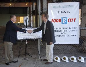 From left, Tom Hembree with Food CIty presents more than $26,000 in proceeds from Food City Race Night to Bill Hartley, executive director of the Birthplace of Country Music Alliance. (Photo by Andre Teague, Bristol Herald Courier)