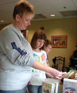Crystal Hubbard and her children, Lauren, 10, and Garret, 8, visit the library every two weeks to check out books and rent movies at no cost.