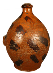 This redware jug found in Sullivan County, Tenn., has been attributed to the Cain pottery of Sullivan County. Lead glazed with manganese decoration, the 19th-century jug had an estimated value of $500-$800. The sale realized $1,012. Condition: missing handle and a chip to the rim of the jug, which is 10-3/4" tall. (Photography by <a href="http://www.JeffreyStonerPhotography.com" rel="external">Jeffrey Stoner</a>)