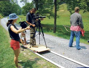Setting up a scene in "This is Not the South" are, left to right, Karen Sabo, producer; Derek Davidson, director (pushing dolly); Tim Altonen, director of photography; and Ryan Perry, actor. 