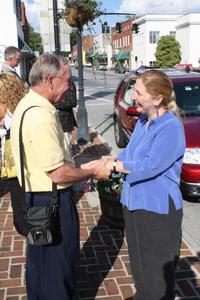 Gary Kimbrell with Advance Abingdon congratulates artist Val Lyle whose rope sculpture, "Entwined Dancers," has been permanently installed in Abingdon's Main Street Park.