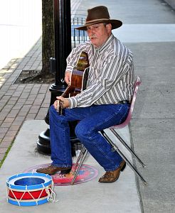 Musician George Goode plays along State Street on Friday. The city of Bristol, Tenn., has begun a new downtown program called Bristol's Busk Stop. The program will allow artists, or buskers, an opportunity to showcase their talent. The performers must obtain a permit and play in one of three marked spots. Performers will be allowed to accept donations in city allocated donation boxes. (Photo by Christopher Bradshaw|Special to the Hearld Courier)