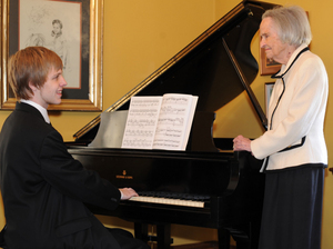 Nate Mitchell and his grandmother, Mrs. Joe E. Mitchell, mentor to two generations of Bristol Music Club scholarship, pictured at Mrs. Mitchell's Steinway piano.