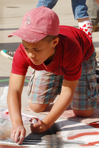 Episcopal School fifth grader Devin Badgett working on his award-winning sidewalk painting. (Photo by Episcopal School of Knoxville eighth grader Evan Nelson)