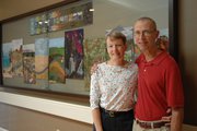 Anne Cowan and her husband, Dr. Ben Cowan stand in front of the 10-panel quilt made by the Blue Ridge Quilter's Guild.
