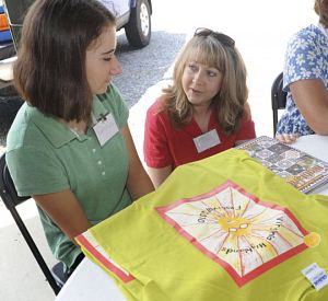 Audra Rasnake, left, who was selected as the 2010 Festival Artist, talks with Audra Yarber during Wednesday's press conference. Yarber's design was selected and used for a t-shirt for this year's festival. (David Crigger | Bristol Herald Courier))