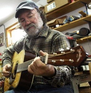 Wayne Henderson plays a recently finished guitar at his workshop in Grayson County, Va. (David Crigger|Bristol Herald Courier)