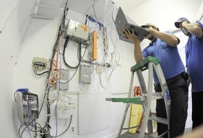 Technicians work on the installation of internet and cable hook-ups in the BVU Pavilion at Rhythm & Roots Reunion. (Earl Neikirk | Bristol Herald Courier)