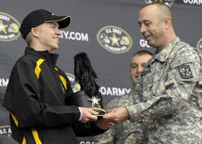 U.S. Army Major Marc Sandefur presents John Battle marching band clarinet player Jonathan Hilgendorf with a shako Monday after being selected to perform at the U.S. Army All-American Bowl in San Antonio, Texas, January 8, 2011. (Andre Teague/Bristol Herald Courier)