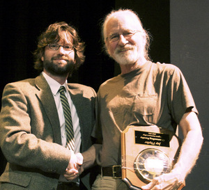 From left, Virginia Intermont Provost Mark Roberts congratulates Jay Phyfer, founder and chair of VI's Photography and Digital Imaging Department.