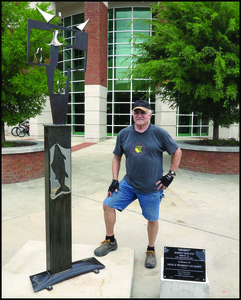 Dr. Marvin Tadlock poses with his sculpture, <em>Ararat</em>. (Photo by Jay Phyfer)
