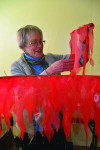 Jan Hurt stands in the center of her "Sun" which is her inspiration for "Cosmos: Mapping the Universe."