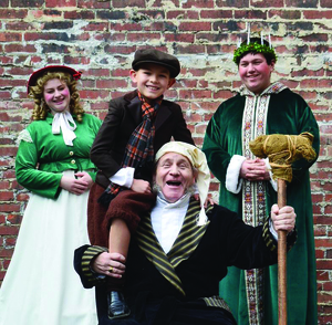 From left to right are Camille Gray (Christmas Past), Coy Owens (Christmas Present), Steve Baskett (Scrooge) and Owen Griffith (Tiny Tim).