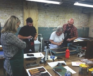 Students learn letterpress during a workshop at The Henderson.