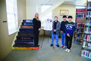 King University junior Anne Franklin, junior Miles Taylor, freshman Minseong Kim, and freshman Yuseon Park post with their newly unveiled stair riser artwork on display at the E.W. King Library at King University.