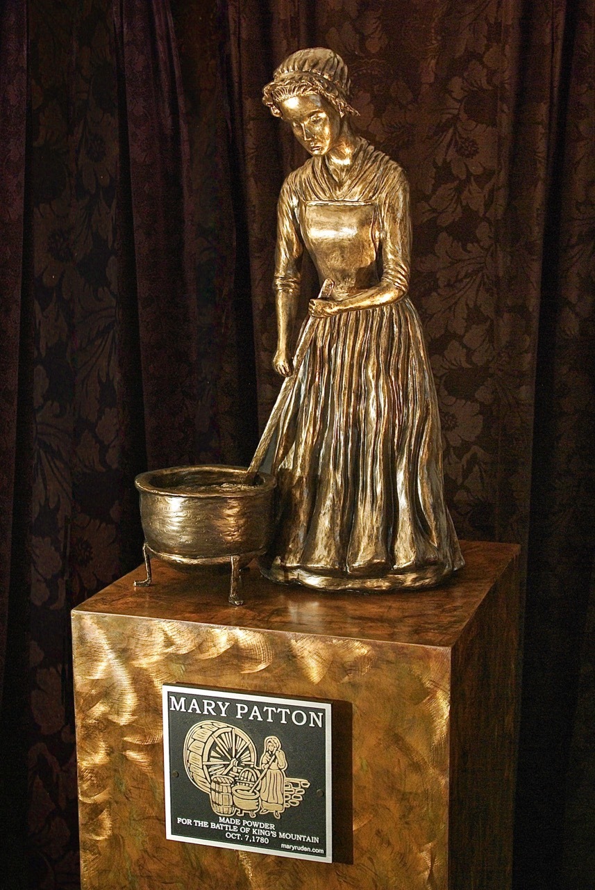 The statue created by Mary Ruden, commemorates  Mary Patton for  making powder for the Battle of Kings Mountain, 1780.