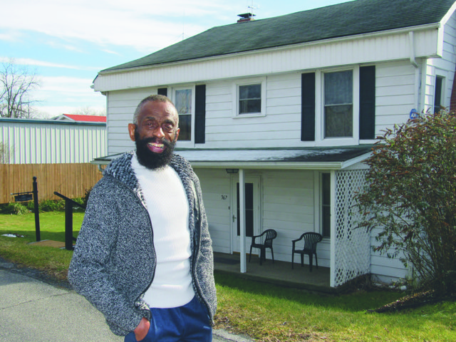 Dr. Jerry Jones in front of his home, the former house of hisgreat-grandfather.  (photo by Carolyn Wilson)