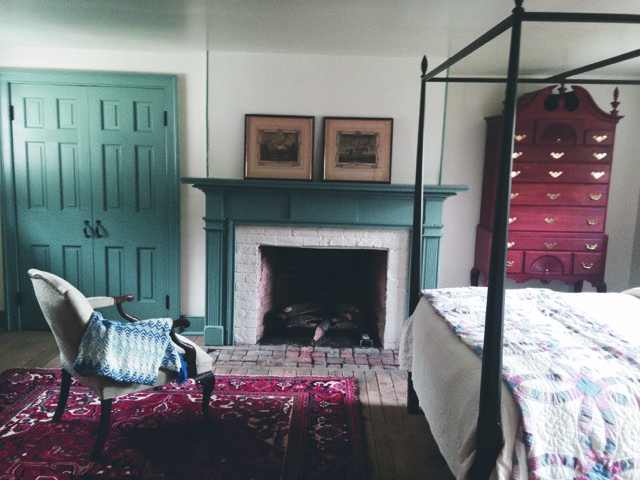 One of the restored bedrooms with original fireplace and brick hearth.
