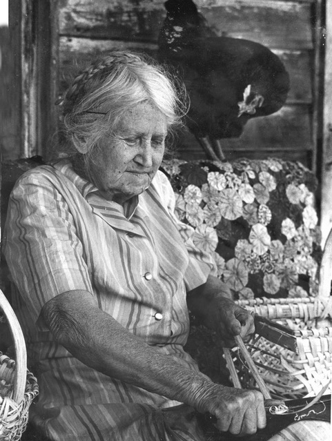 Mary Helton is seen here with her pet chicken. Helton, a basket maker,  was one of the first members in Holston Mountain Arts and Crafts Coop- erative. (Photo by Bill Blanton)