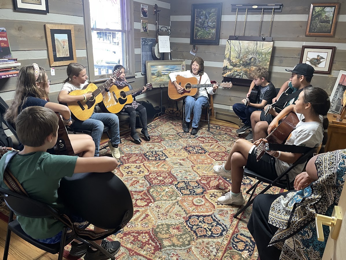 Junior Appalachian Musicians (JAM), in Lois Dunn's guitar class, practice for the upcoming Tuesday, December 9, Old Fashion Appalachian Christmas fundraiser.